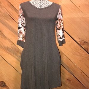 Grey dress with 3/4 length floral print sleeves.